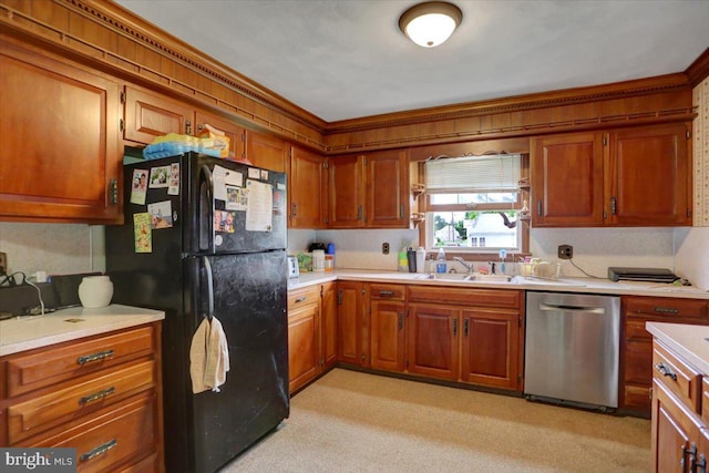 kitchen with black fridge, sink, light colored carpet, and stainless steel dishwasher