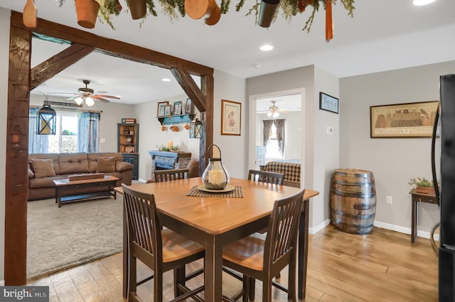 dining room with light hardwood / wood-style floors and ceiling fan