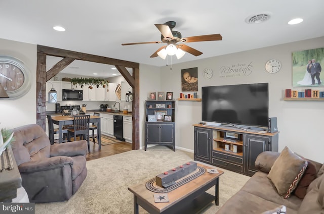 living room with ceiling fan, hardwood / wood-style floors, and sink