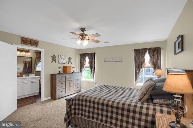 bedroom featuring sink, ceiling fan, carpet floors, and ensuite bathroom