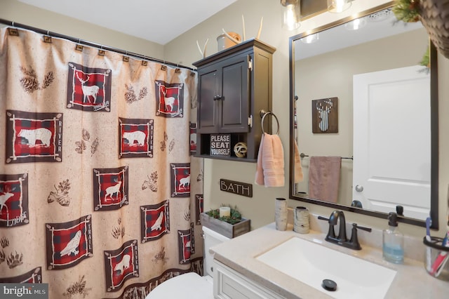 bathroom featuring vanity and toilet