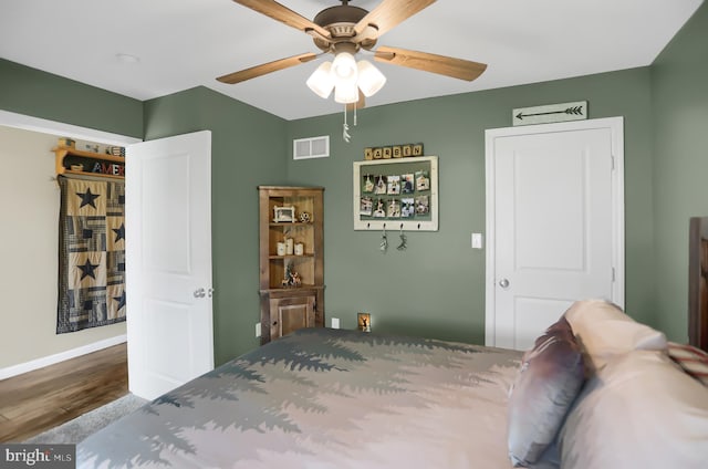 bedroom with ceiling fan, a closet, and hardwood / wood-style flooring