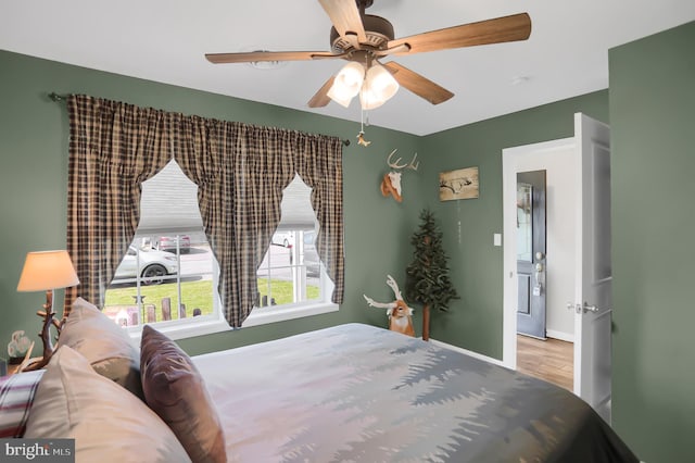 bedroom with hardwood / wood-style flooring and ceiling fan