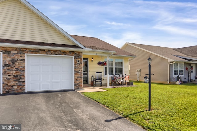 view of front of property with a garage and a front lawn