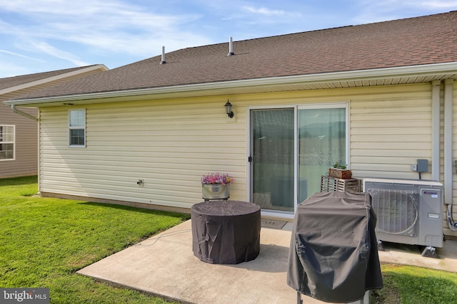 rear view of house featuring a patio area and a lawn