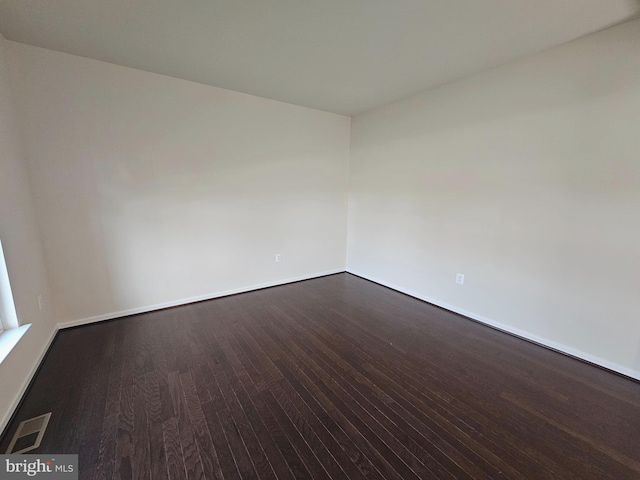 unfurnished room featuring dark hardwood / wood-style floors