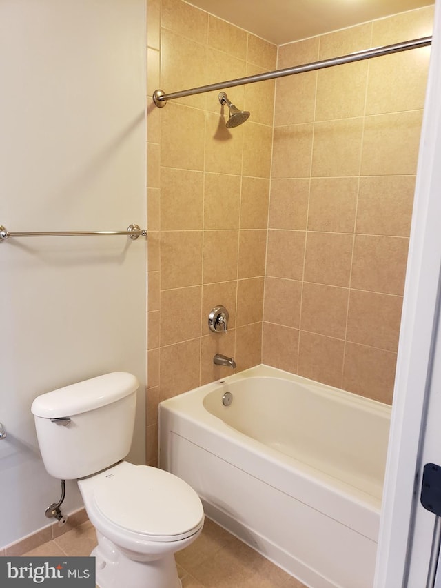 bathroom with tile flooring, tiled shower / bath, and toilet