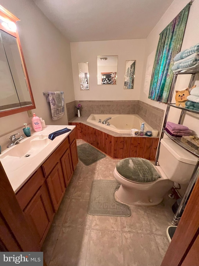 bathroom with tile patterned floors, vanity, a bathtub, and toilet