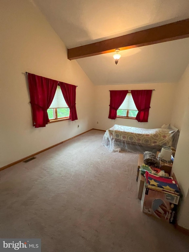 bedroom featuring carpet and vaulted ceiling with beams