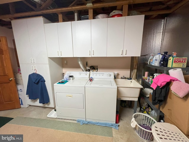 clothes washing area featuring cabinets, independent washer and dryer, and sink