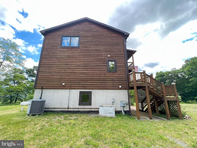 view of property exterior with central AC unit, a deck, and a yard