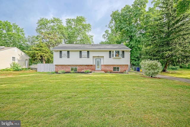 split foyer home with a front lawn