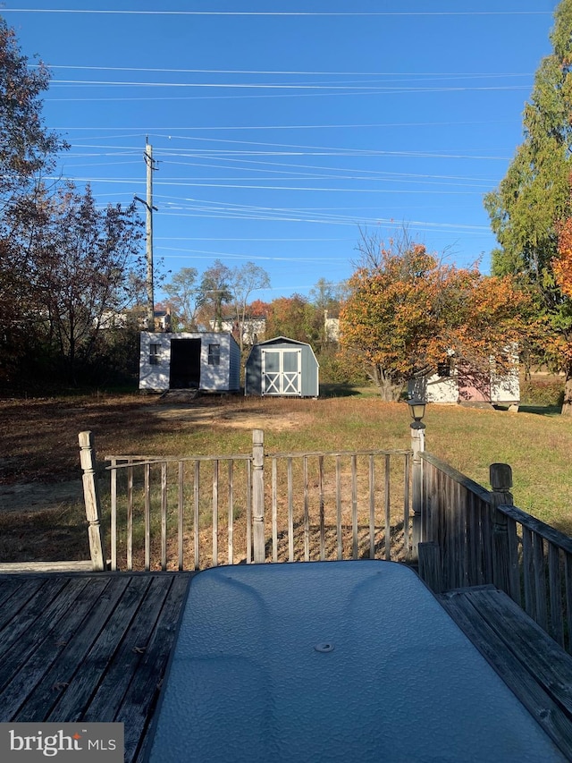 view of yard featuring a storage shed and a wooden deck