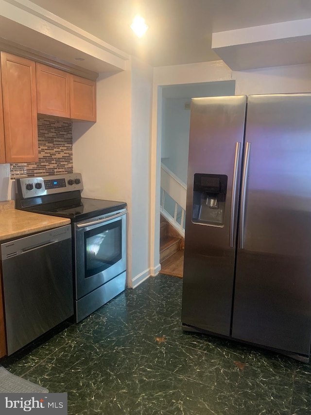 kitchen featuring appliances with stainless steel finishes and tasteful backsplash