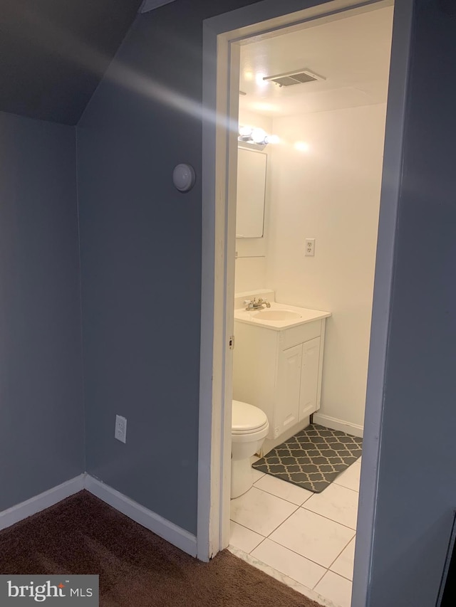 bathroom with vanity, toilet, and tile patterned floors