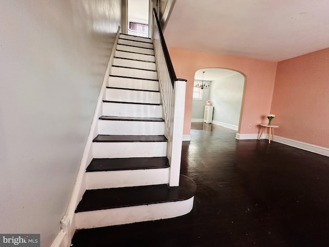 stairs with dark hardwood / wood-style floors