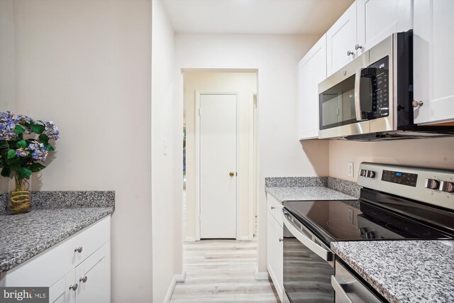18503 Sweet Autumn Dr Unit 201, Gaithersburg, MD 20879 - kitchen with stainless steel appliances, light wood-type flooring, white cabinetry, and light stone countertops