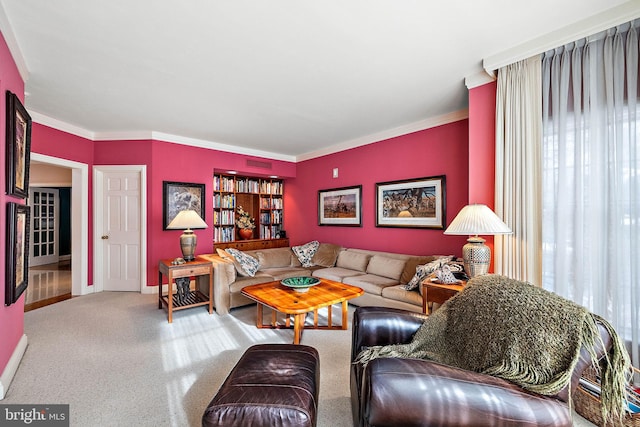 carpeted living room with crown molding