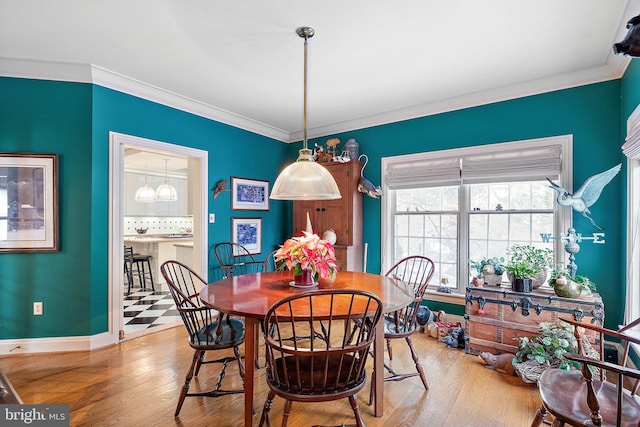 dining area featuring ornamental molding and hardwood / wood-style floors