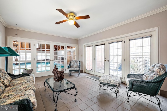 tiled living room featuring french doors, ornamental molding, and ceiling fan