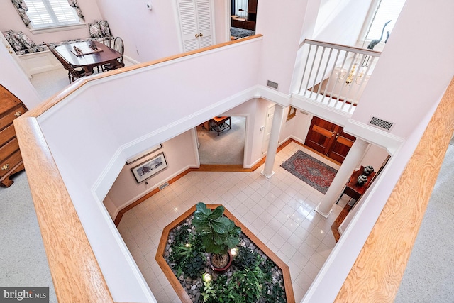 interior space with tile flooring and a high ceiling