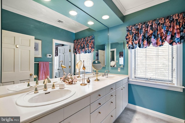 bathroom with dual bowl vanity and crown molding