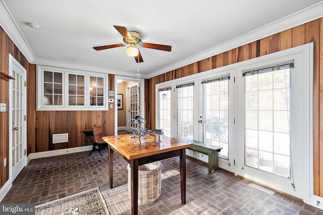 office featuring ceiling fan, french doors, wood walls, and ornamental molding