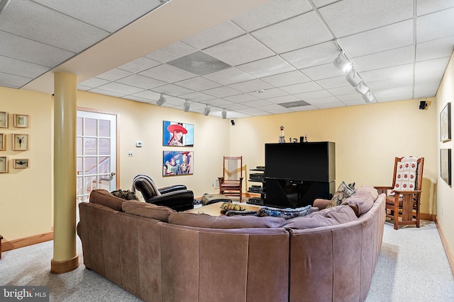 carpeted living room with a drop ceiling and rail lighting