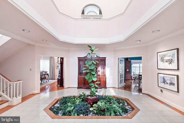 entryway featuring ornamental molding and hardwood / wood-style floors