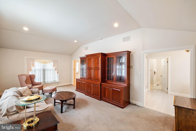 living room with lofted ceiling and light carpet