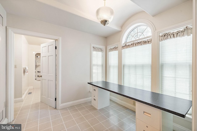 unfurnished office featuring light tile floors