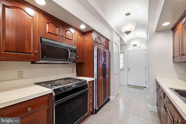 kitchen featuring pendant lighting, black appliances, and light tile floors