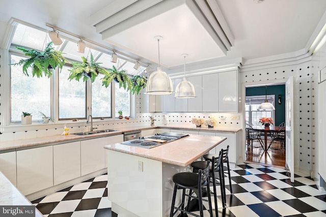 kitchen with backsplash, sink, light tile floors, and a kitchen island