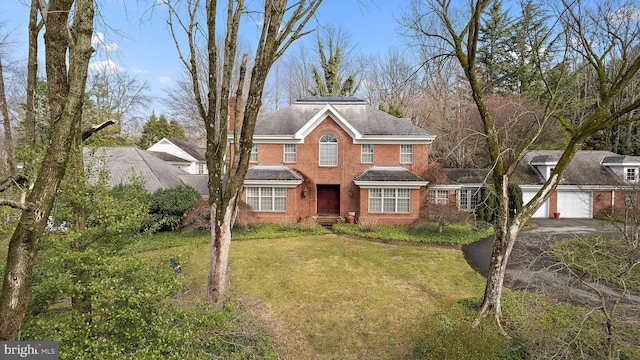 view of front property featuring a garage and a front lawn