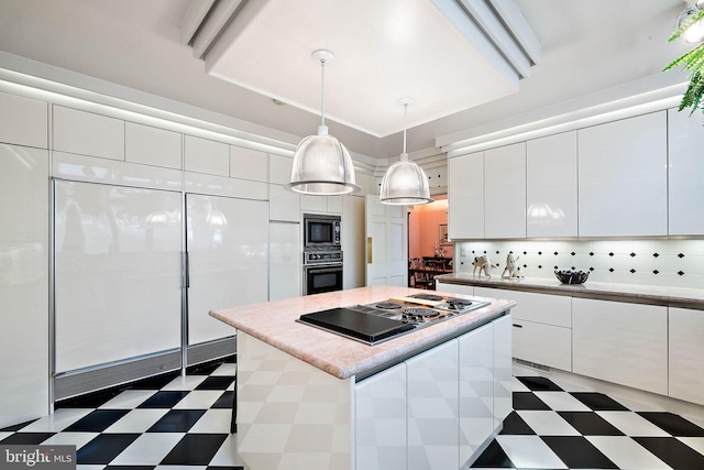 kitchen featuring a center island, black appliances, white cabinets, tile floors, and decorative light fixtures