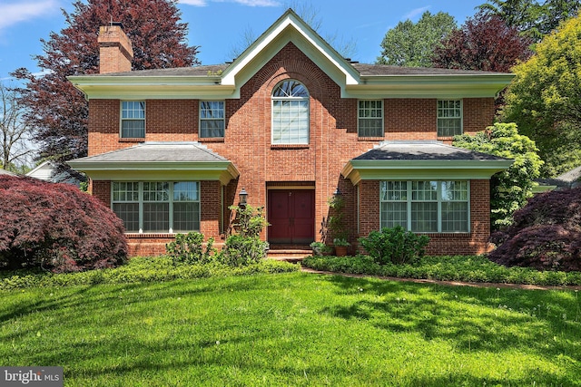 colonial inspired home featuring a front yard