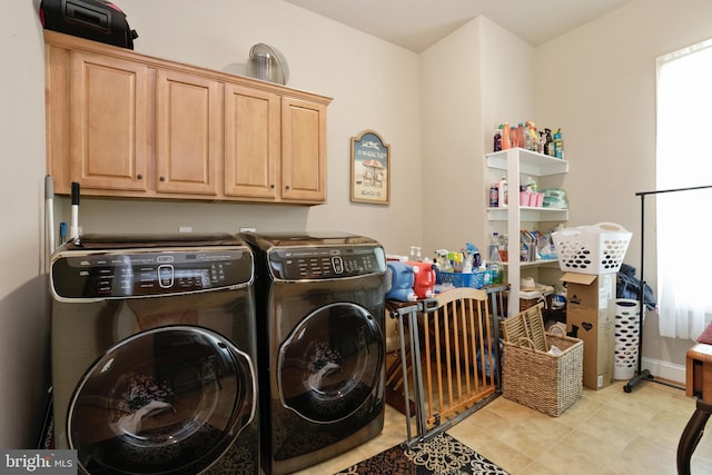 washroom featuring separate washer and dryer, cabinets, and light tile floors