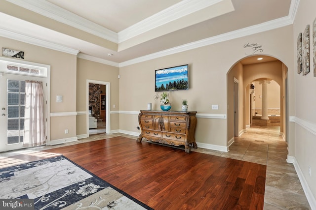 sitting room with ornamental molding, hardwood / wood-style flooring, and a tray ceiling