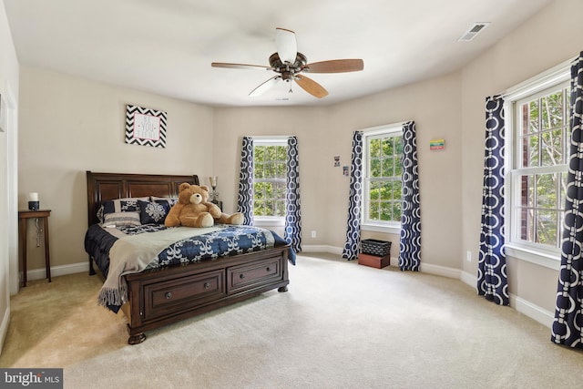 bedroom featuring light carpet and ceiling fan