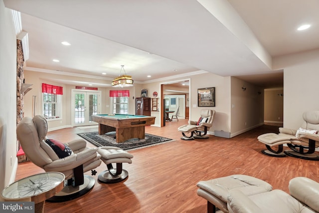 living room featuring crown molding, french doors, hardwood / wood-style floors, and pool table