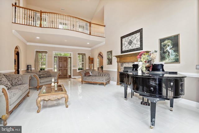 living room featuring a high ceiling, tile flooring, and crown molding