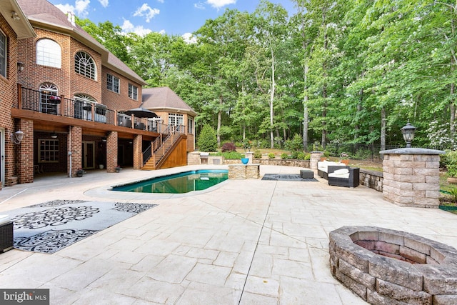 view of swimming pool with a deck and a patio area