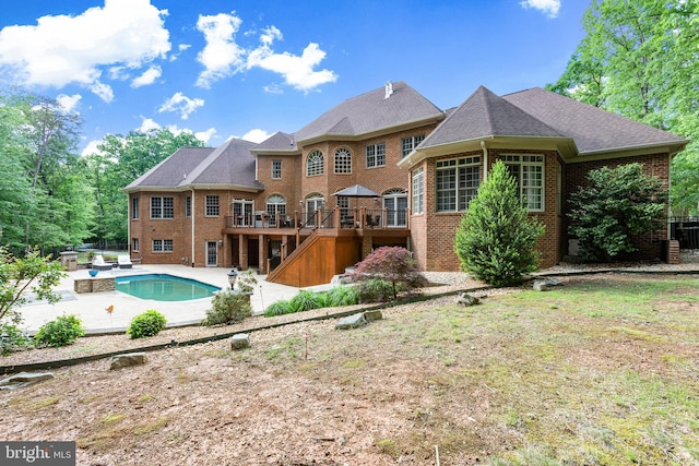 back of property featuring a swimming pool side deck