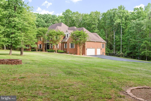 cape cod house featuring a garage and a front yard