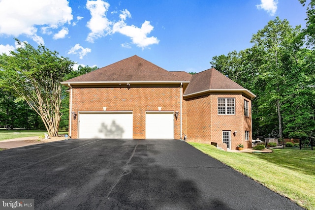 view of side of home with a garage and a yard