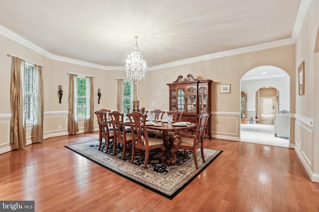 carpeted dining space featuring a notable chandelier and crown molding