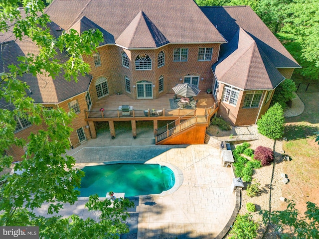 view of swimming pool featuring a deck and a patio area