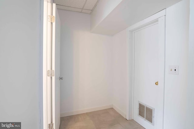 walk in closet with light tile flooring and a paneled ceiling