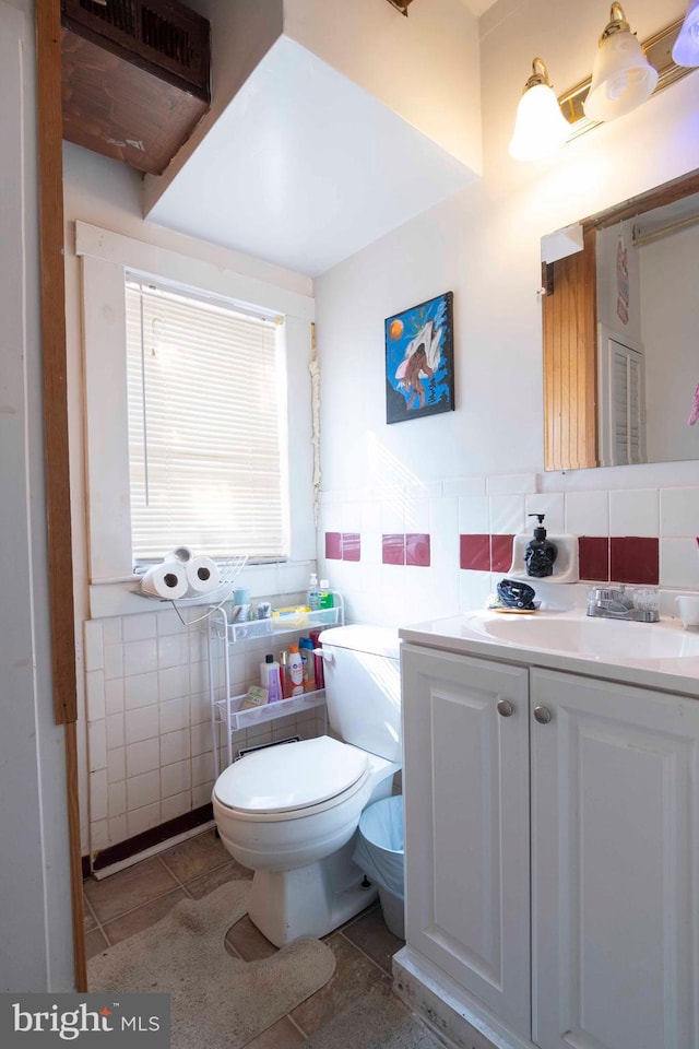 bathroom featuring backsplash, tile walls, toilet, and tile floors