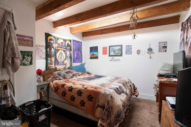 carpeted bedroom with beam ceiling